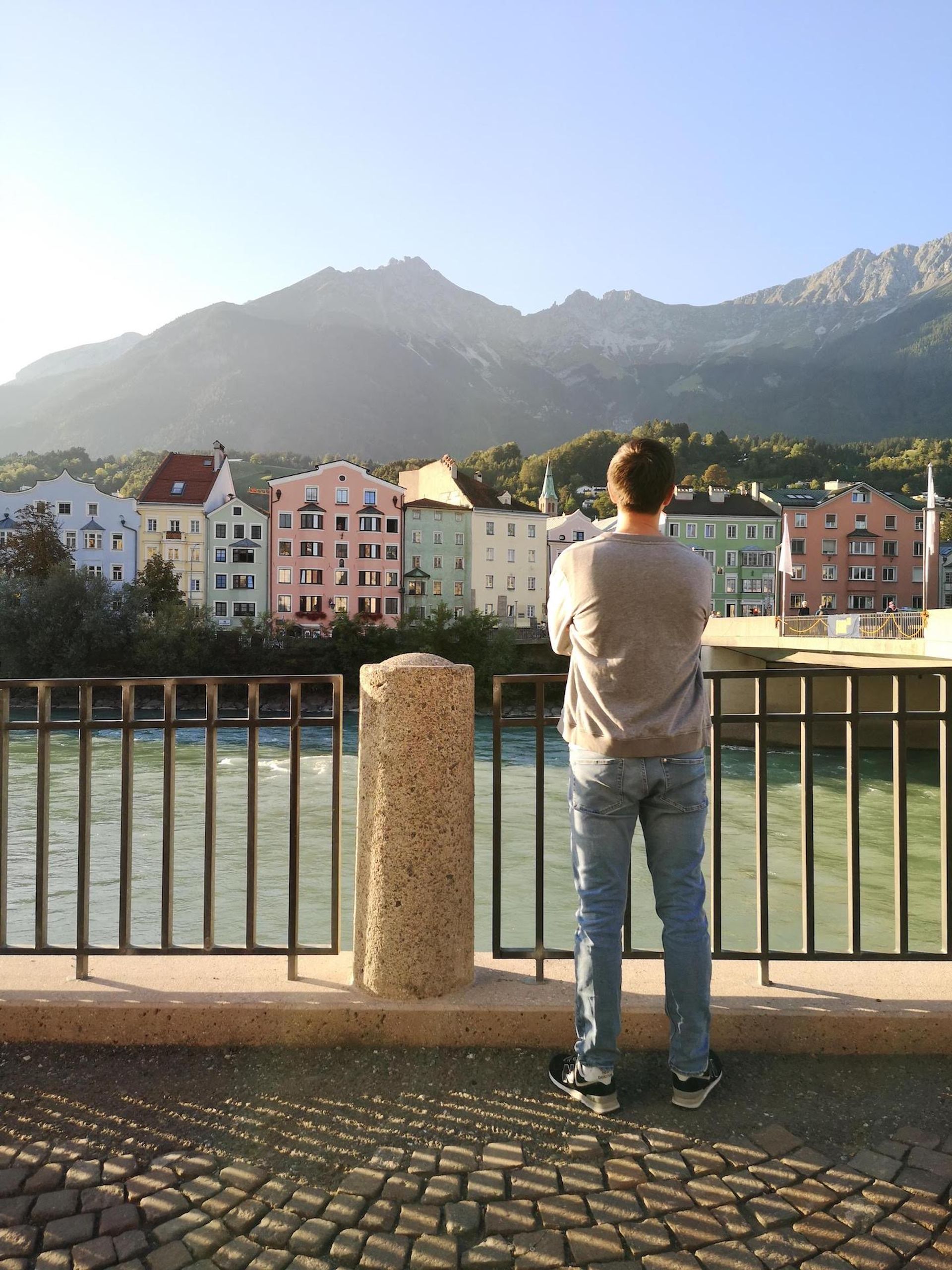 Mountains and houses, person standing in front of them